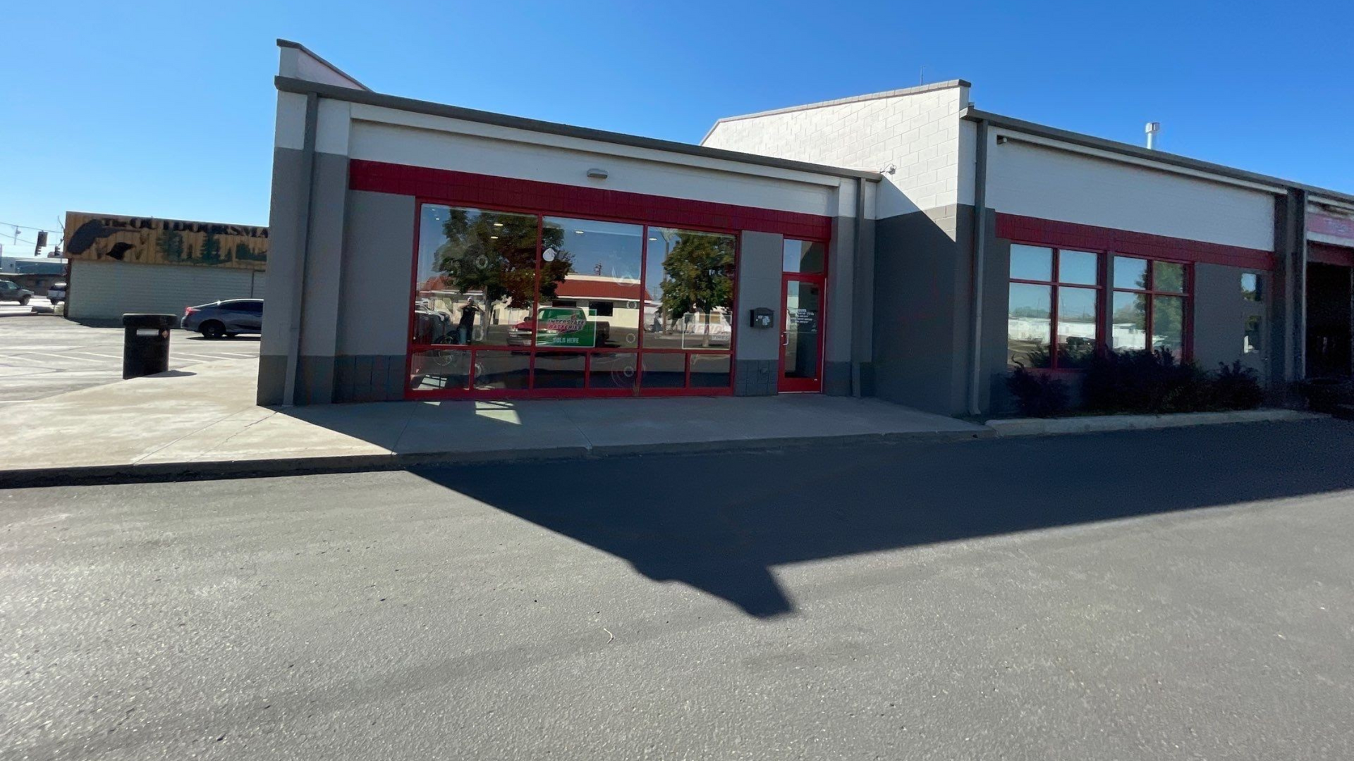 Commercial building with red trim and gray exterior paint in Boise