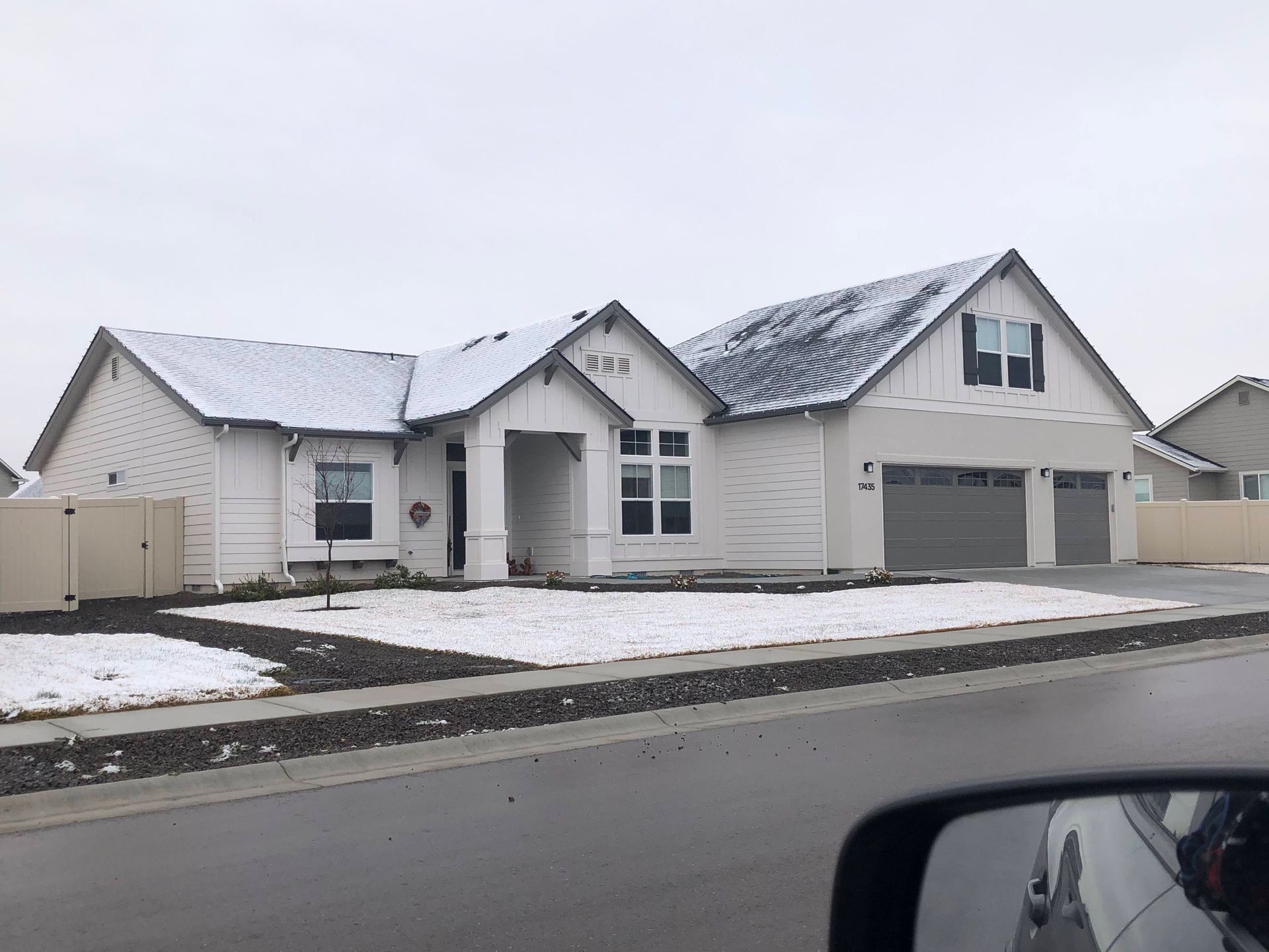 A large white house with snow on the roof
