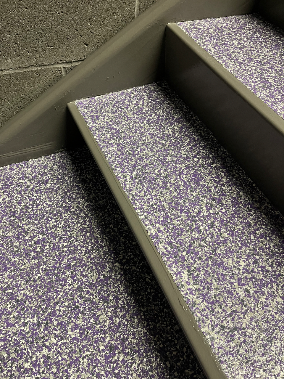 A set of stairs with purple and white steps