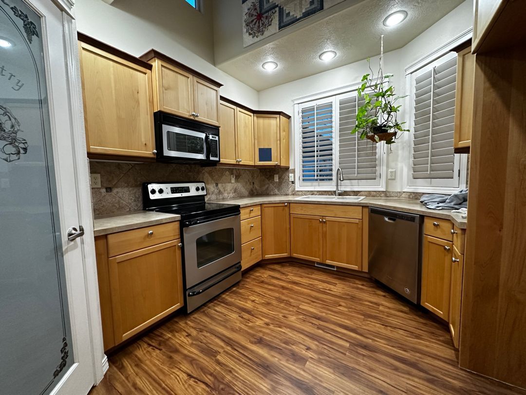 A kitchen with wooden cabinets and stainless steel appliances.