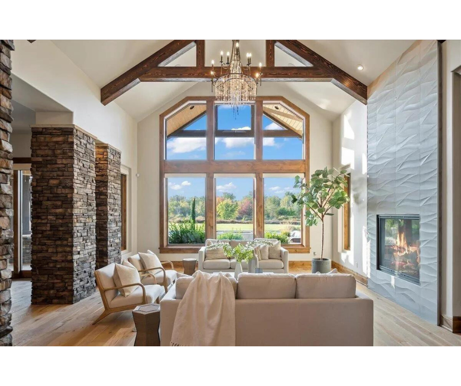 A living room with a lot of windows and a fireplace