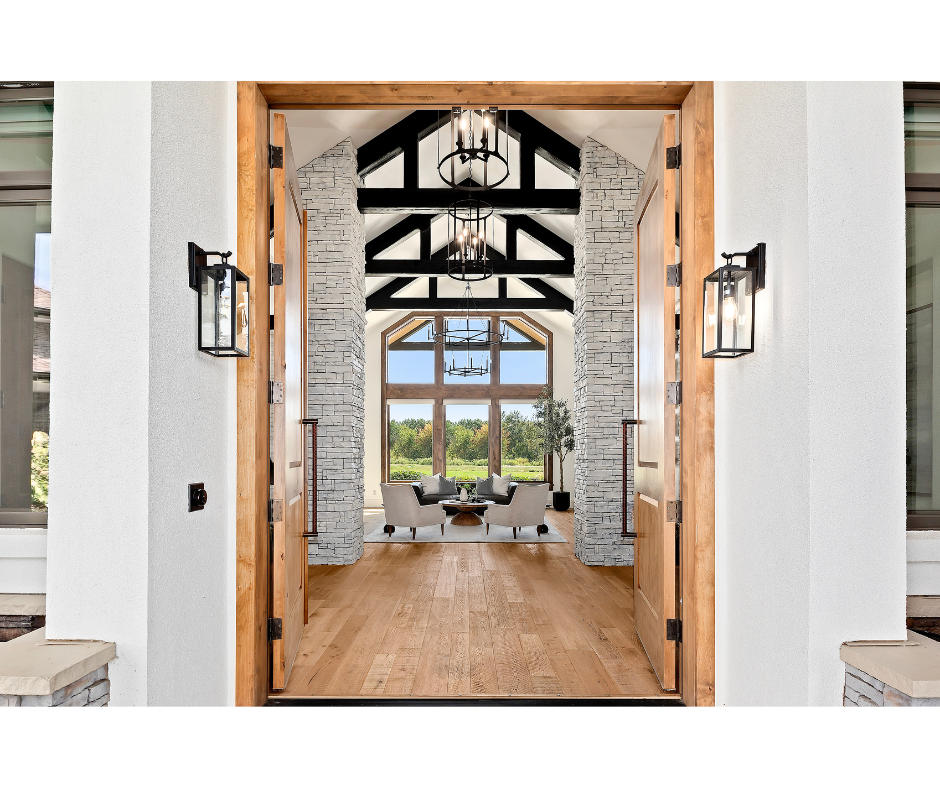 A view of a living room from the front door of a house.