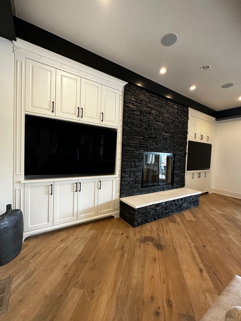 A living room with a fireplace and a flat screen tv.
