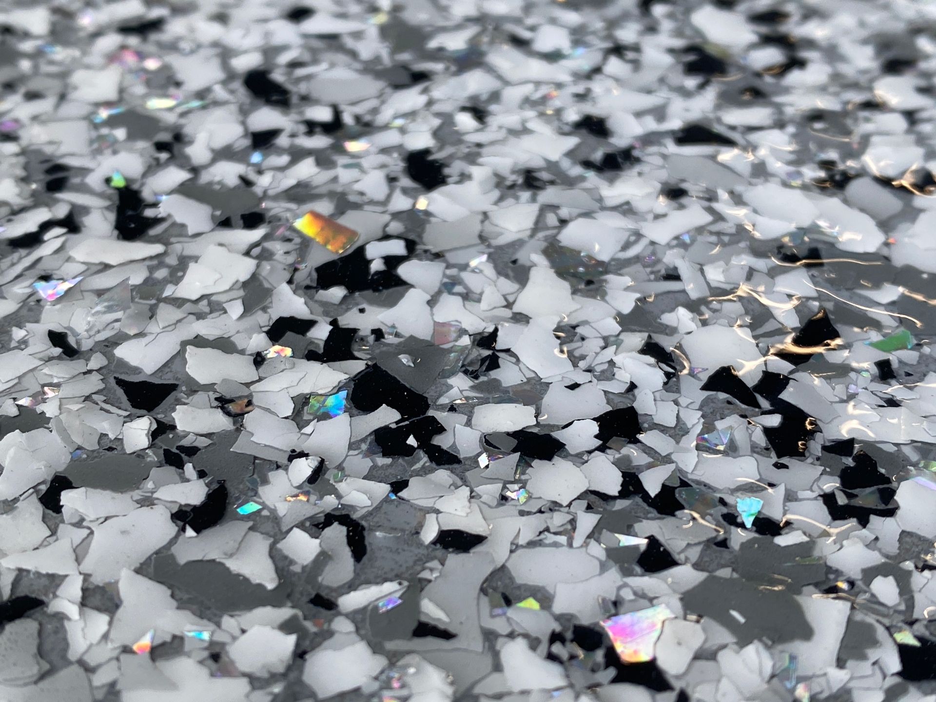 A close up of a white and black glitter surface.