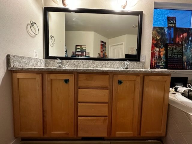 A bathroom with two sinks and a large mirror