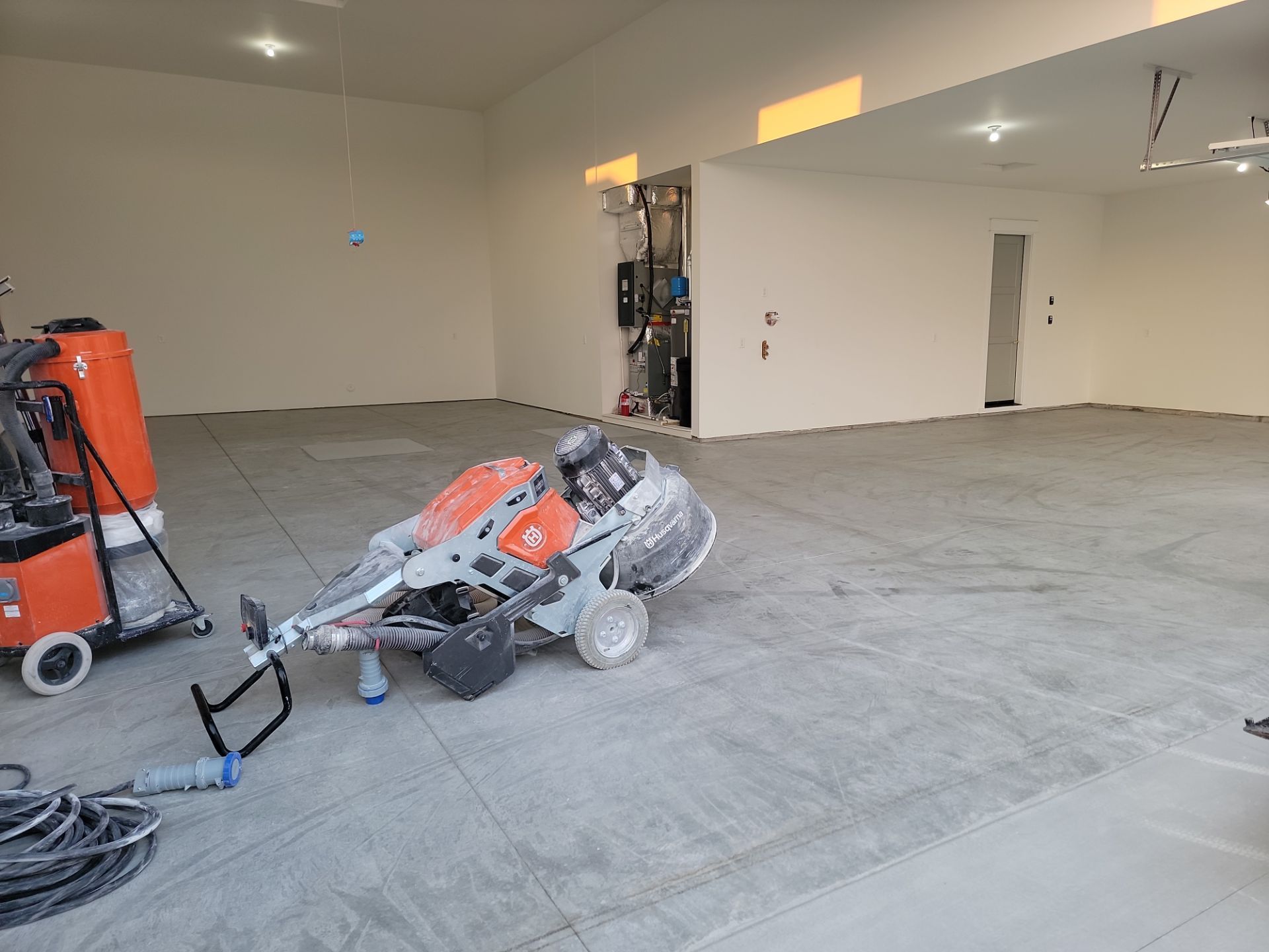 A machine is sitting on a concrete floor in a room.