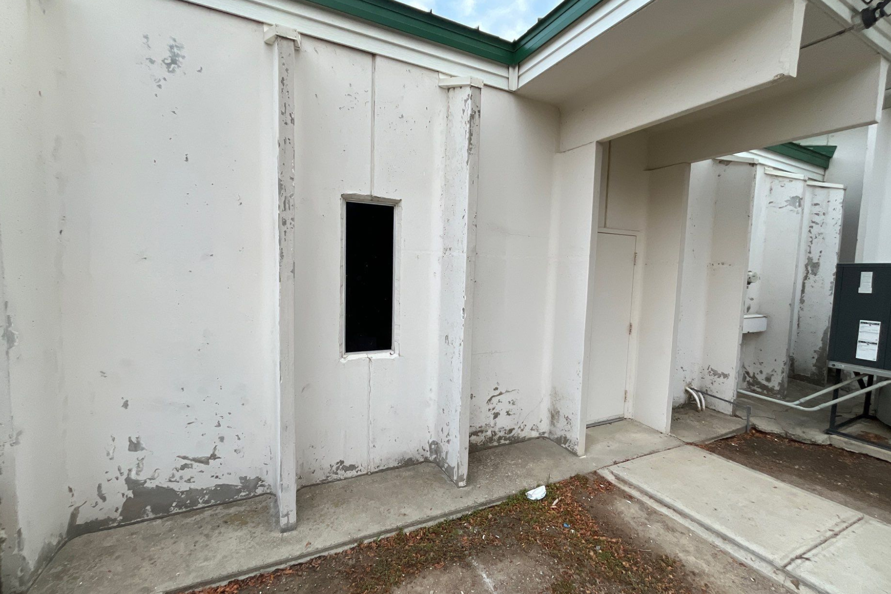 There is a window in the wall of a building.