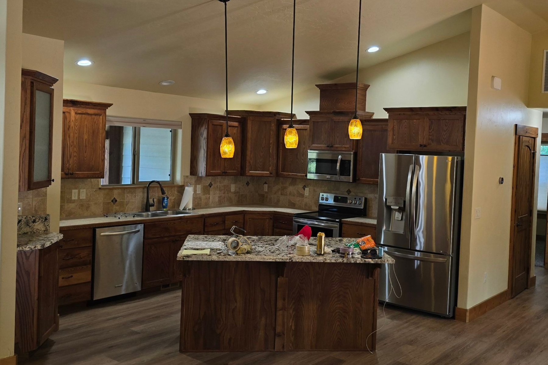 A kitchen with stainless steel appliances and wooden cabinets.