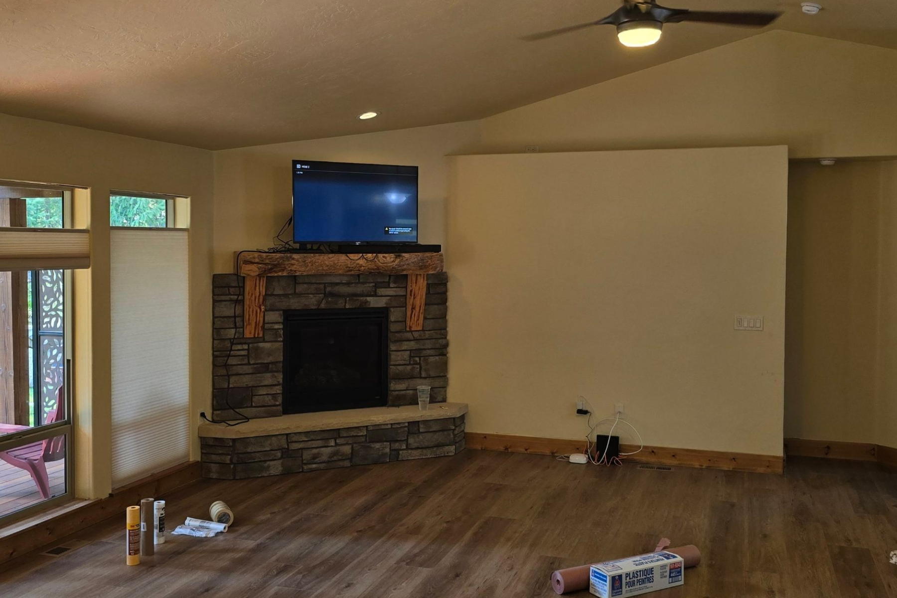 A living room with a fireplace and a flat screen tv.