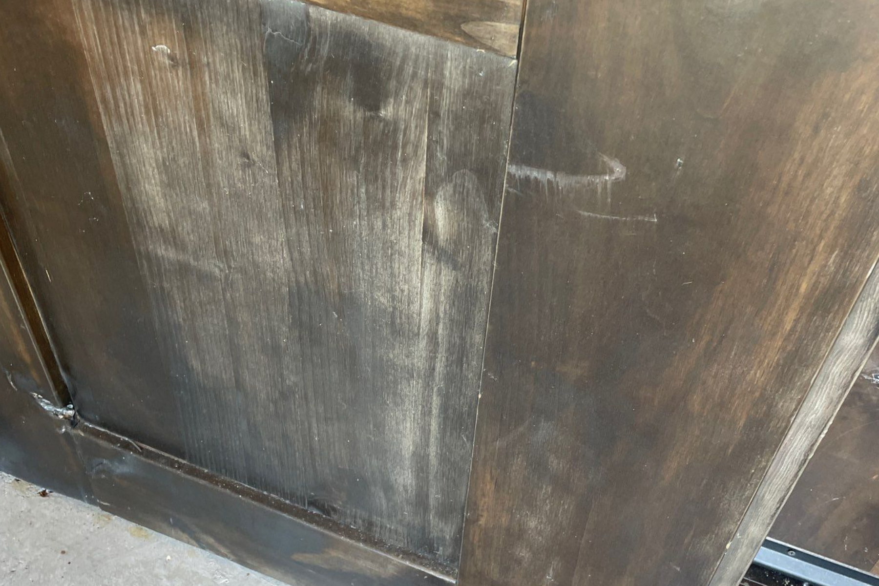 A close up of a piece of wood with a scratch on it.