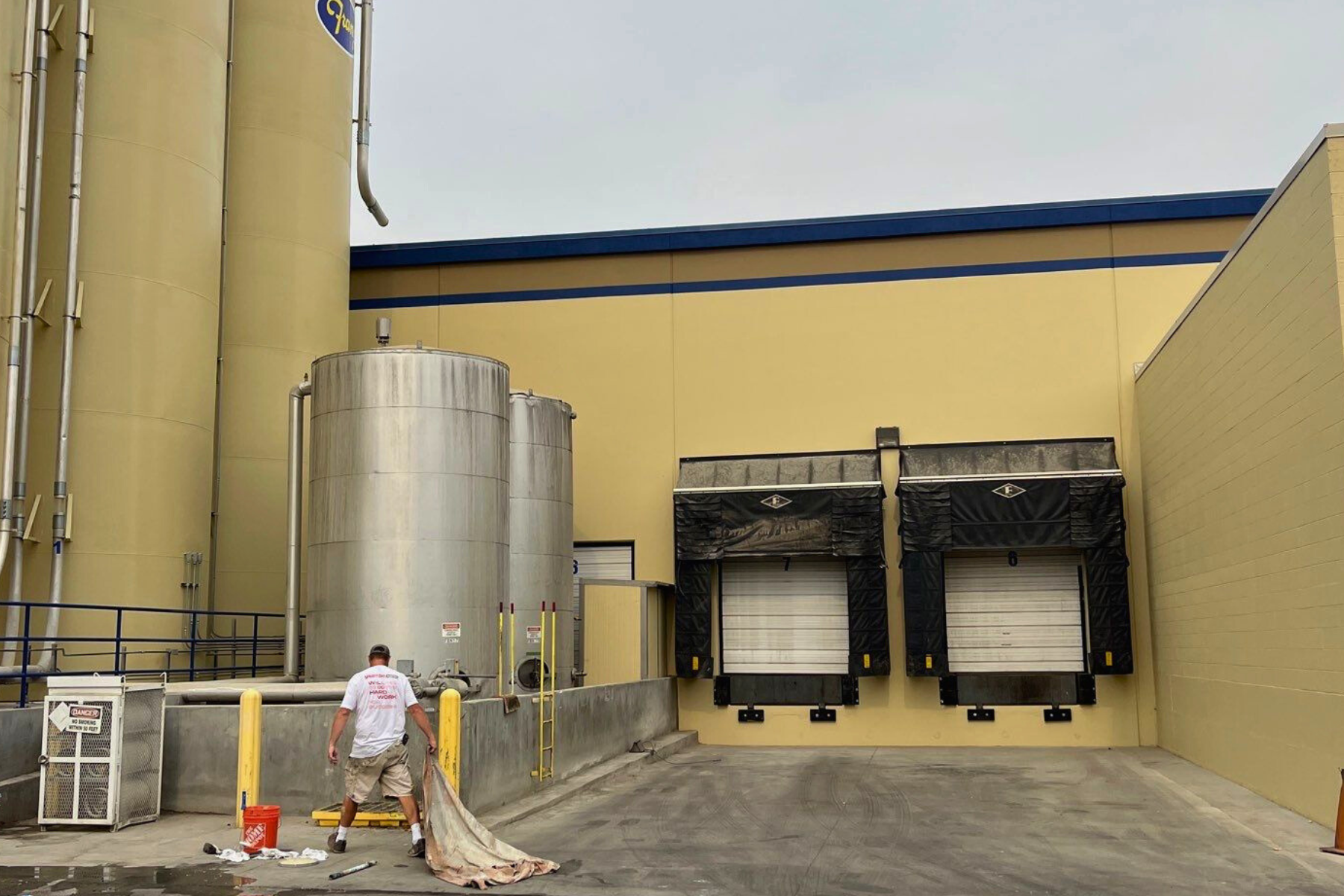 A man is painting the outside of a building