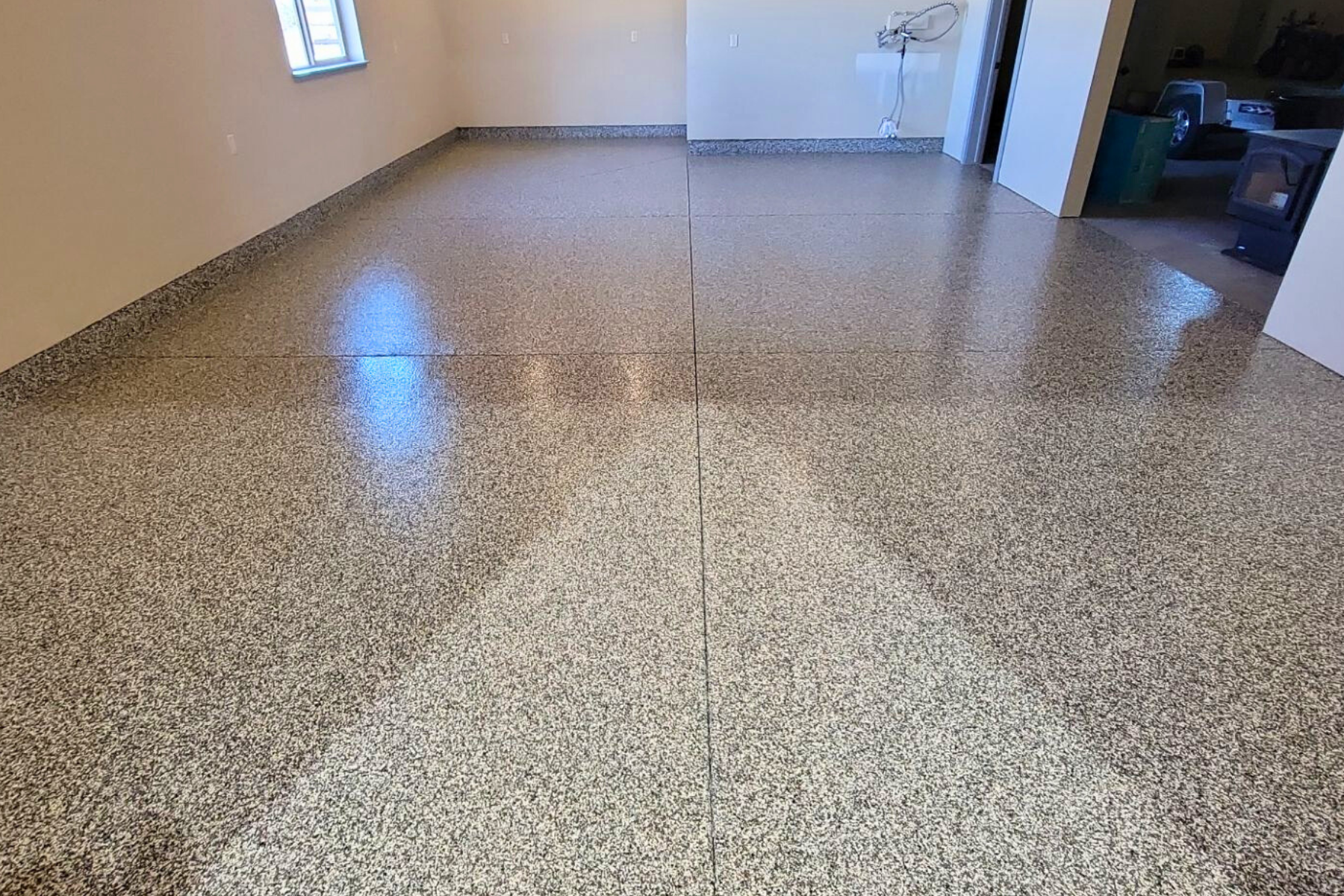 A room with a shiny floor and a window.