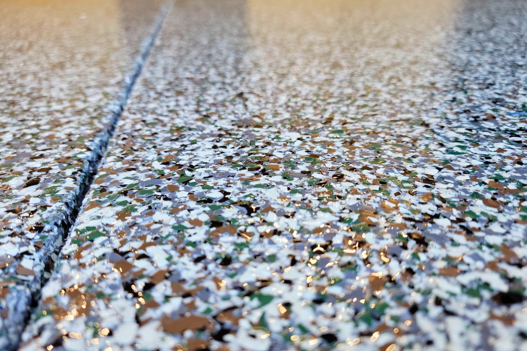 A close up of a concrete floor with a lot of small stones on it.