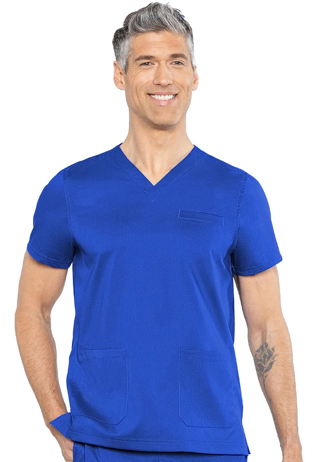 Man in royal blue medical scrubs smiles, poses.