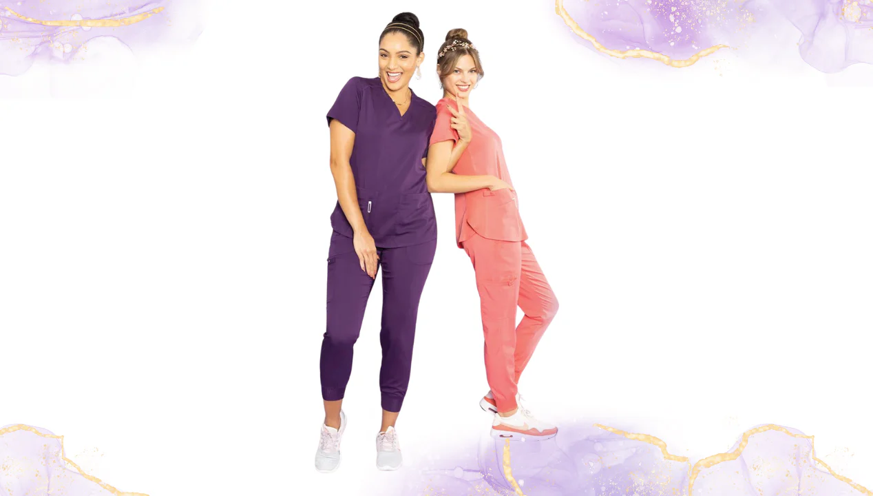 Two women in scrubs, purple and coral, smiling in front of a white background with gold accents.