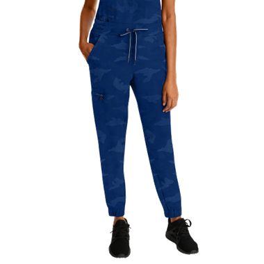 Woman wearing blue camouflage pants and black sneakers.