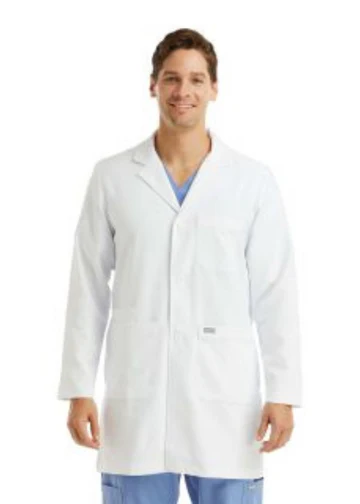 Man in white lab coat smiling, wearing scrubs.
