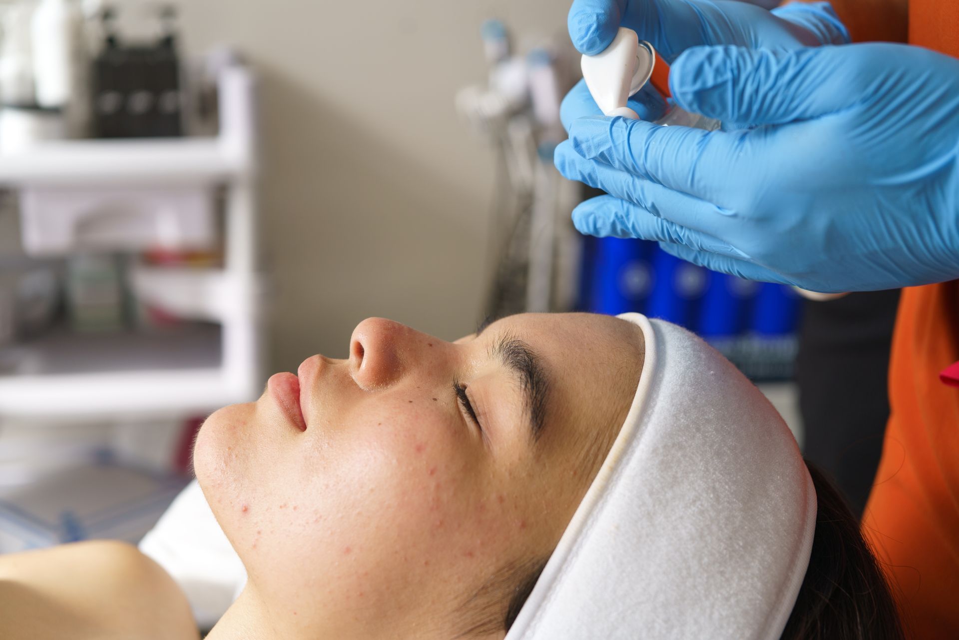A woman is getting a facial treatment at a beauty salon.