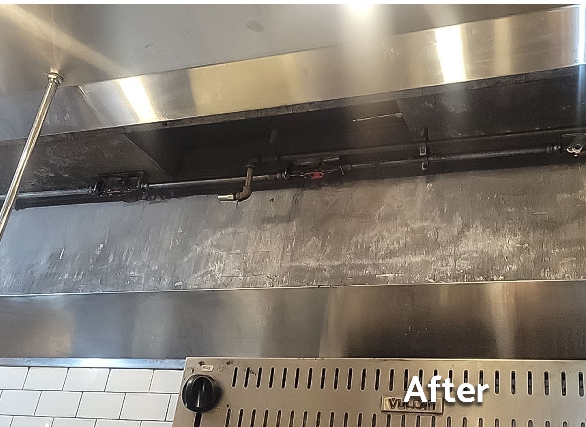 A picture of a stainless steel hood with the words after written on it