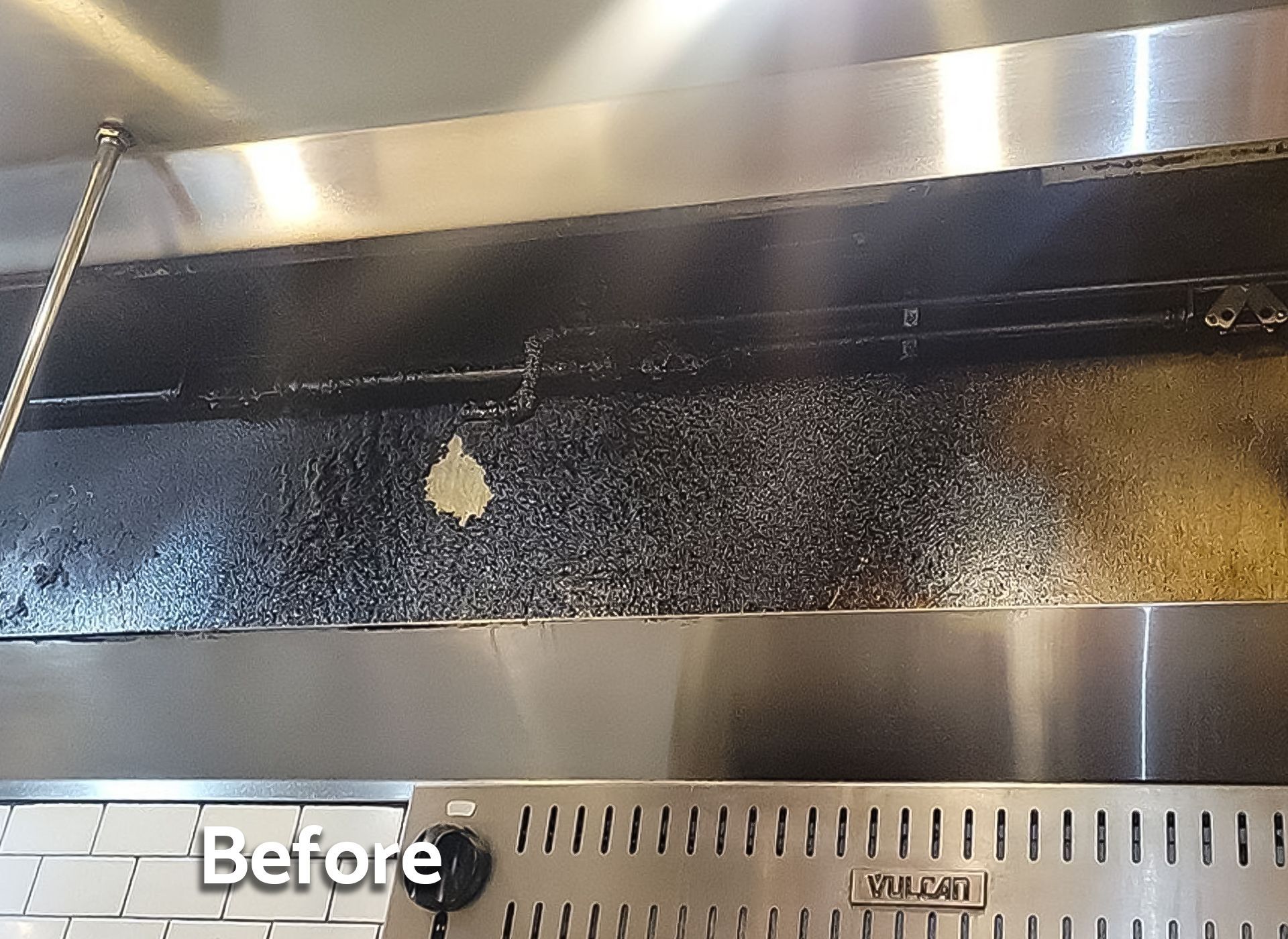 A picture of a kitchen hood before being cleaned
