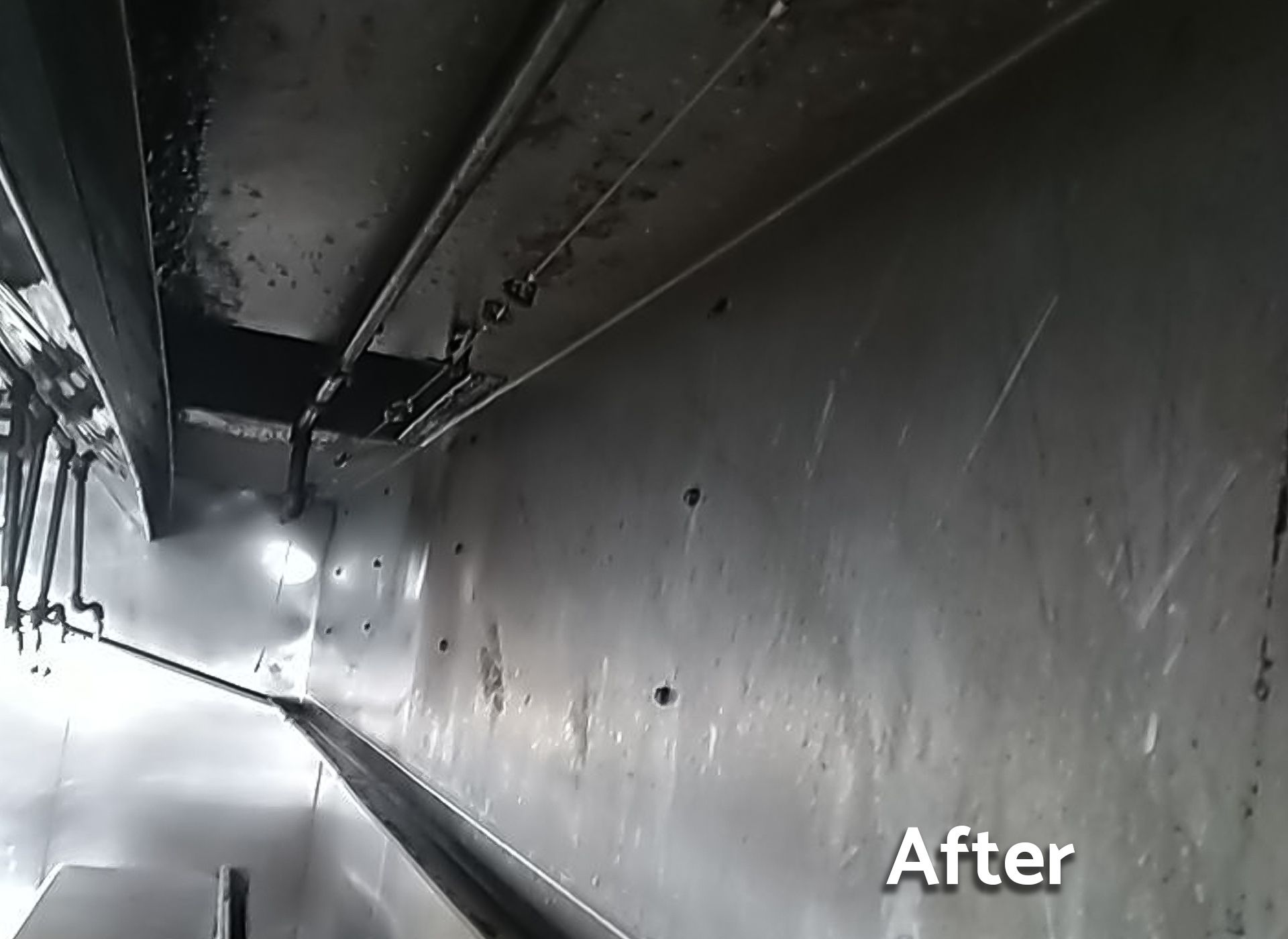 A picture of a kitchen hood after being cleaned.