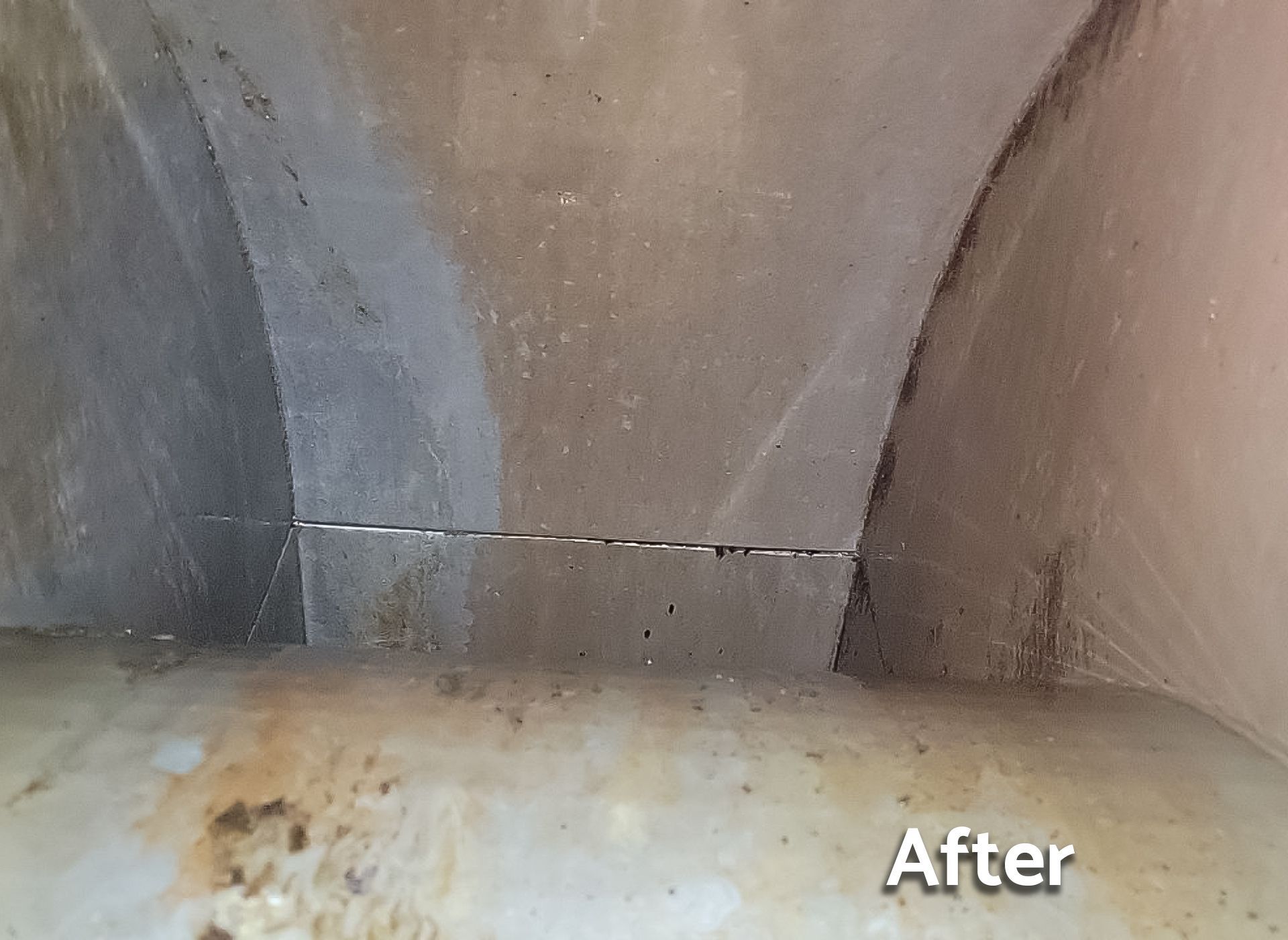 A picture of a concrete wall before and after cleaning.