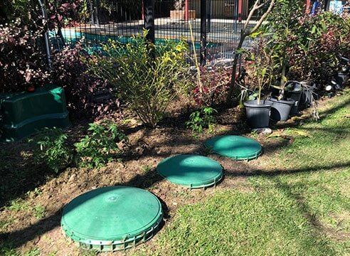 Septic and wastewater tanks installed in backyard