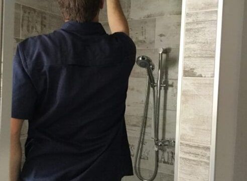 plumber conducting regular plumbing maintenance for new home