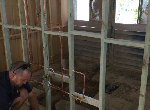 Plumber installing pipes during renovation in gladstone