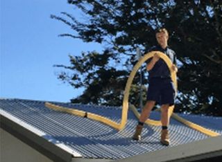 Plumber on house roof in Gladstone -plumbing gladstone