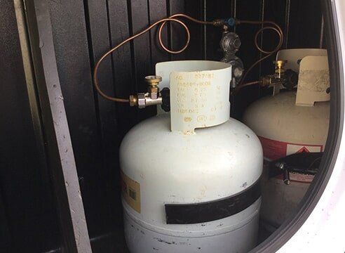 two gas bottles installed under bbq