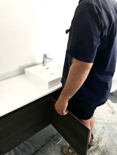 Plumber installing sink with black drawer in Gladstone - Plumbing Gladstone