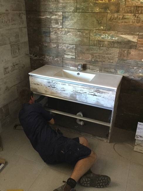 Plumber repairing sink in Gladstone - Plumbing Gladstone