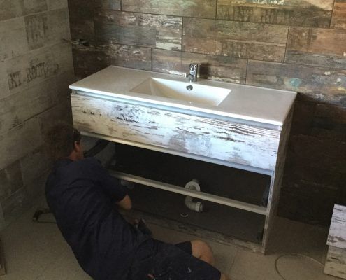 Plumber fixing sink — recent plumbing work in Gladstone, QLD