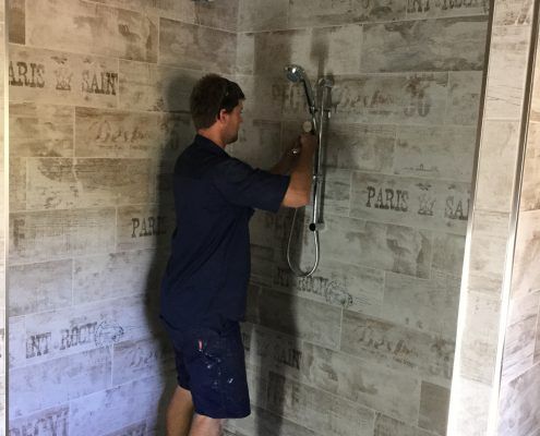 Plumber fixing shower — recent plumbing work in Gladstone, QLD