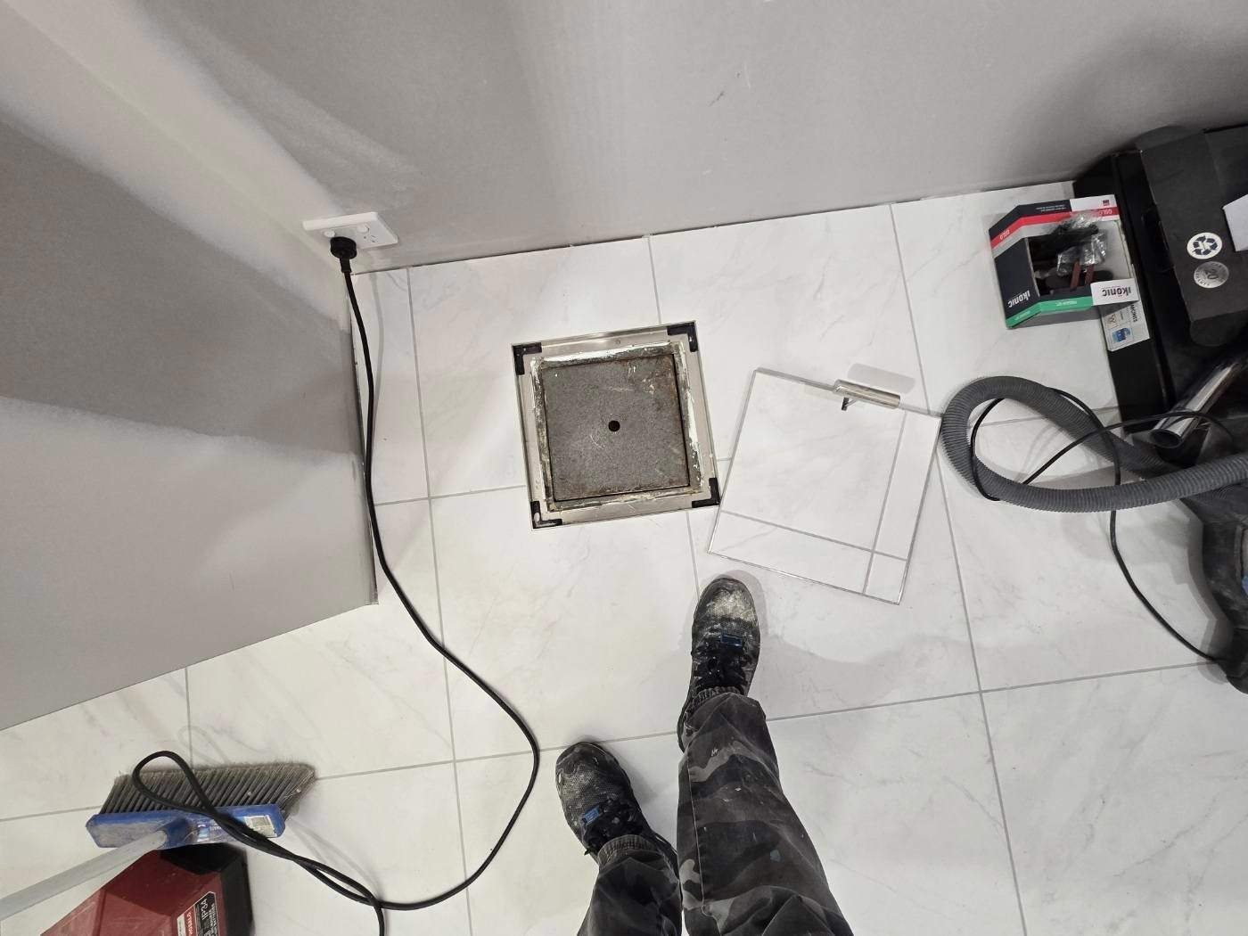 Person Standing Near An Open Floor Access Panel In A Room — David Son Tiling in Springdale Heights, NSW