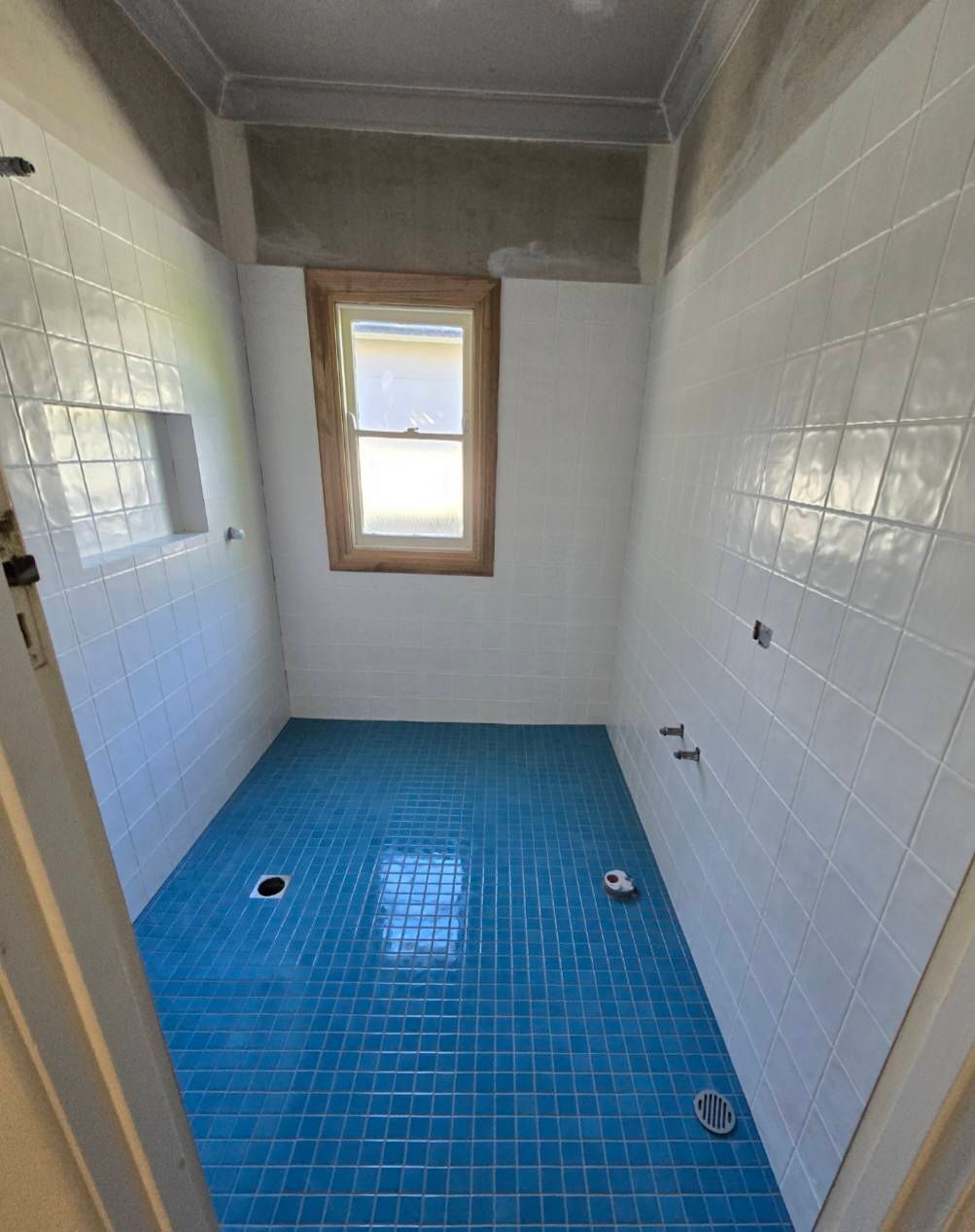 Blue-tiled Shower Room With White Walls And Small Window. — David Son Tiling in Springdale Heights, NSW