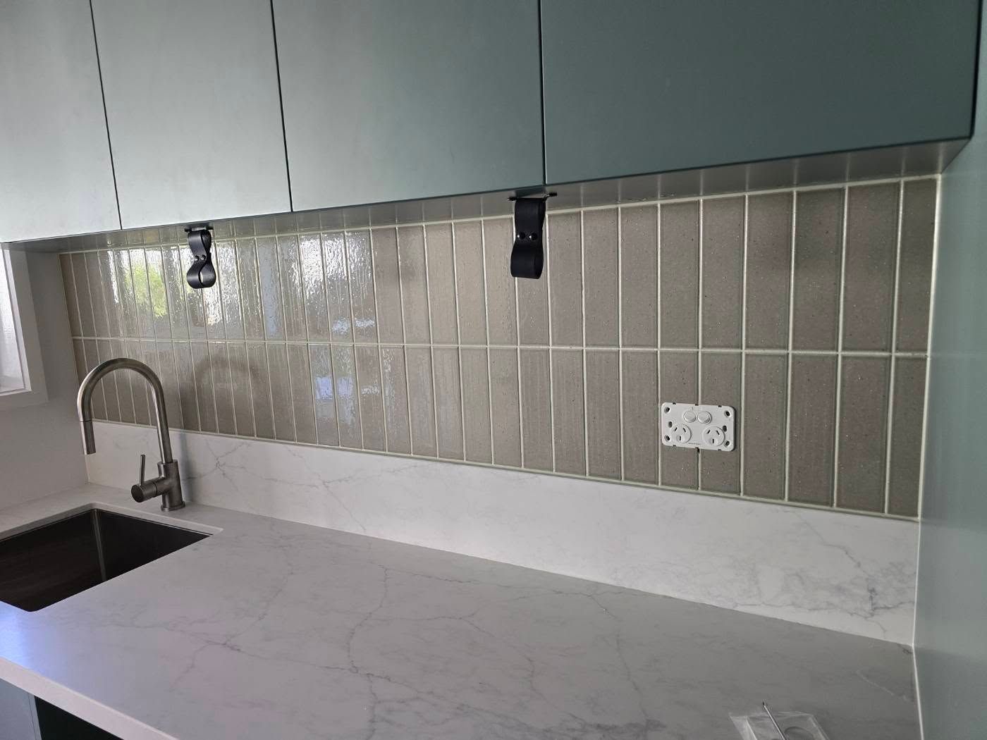 Kitchen Backsplash With Grey Vertical Tiles, White Countertop — David Son Tiling in Springdale Heights, NSW