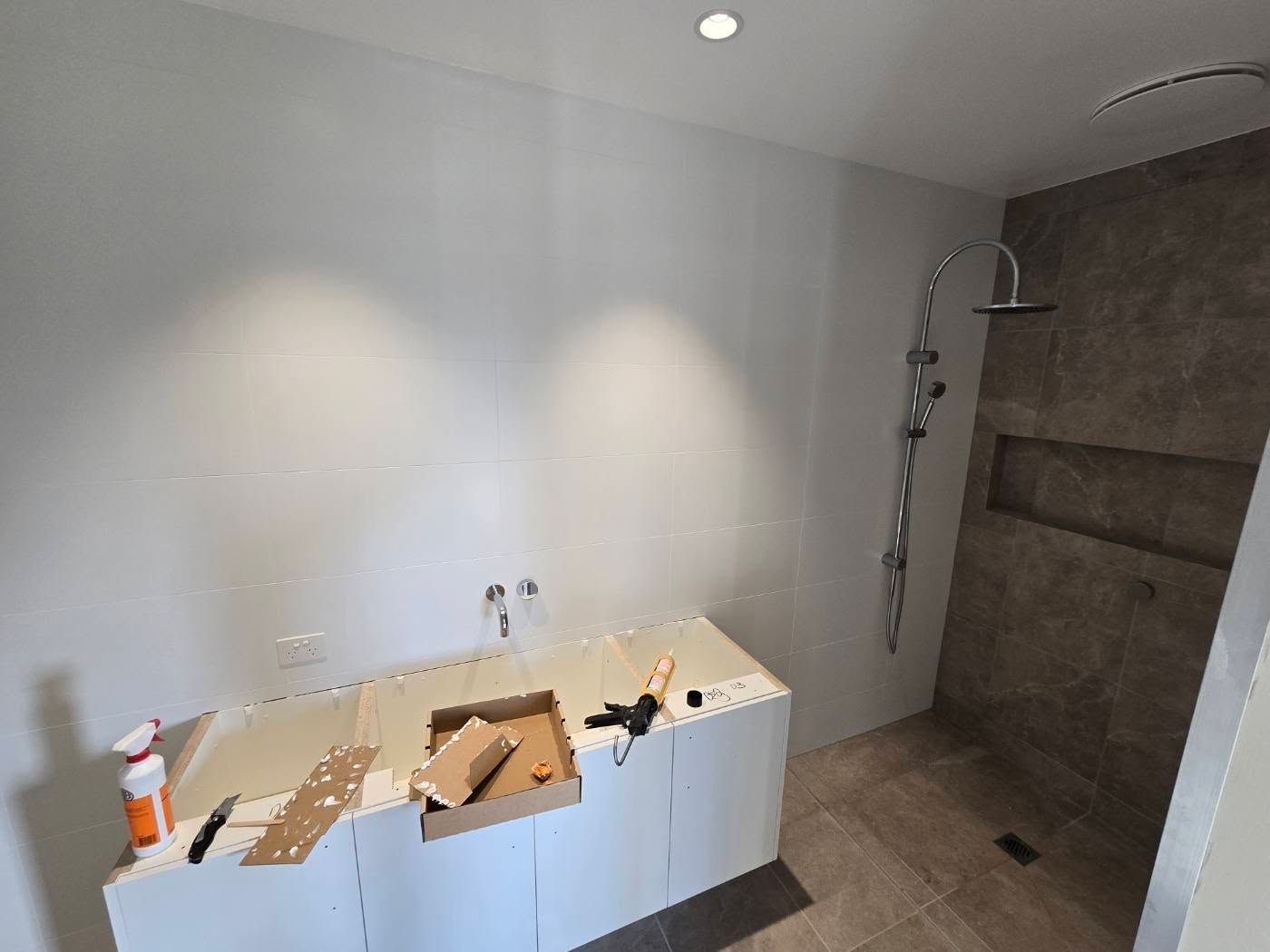 Bathroom Under Construction With White Vanity — David Son Tiling in Springdale Heights, NSW