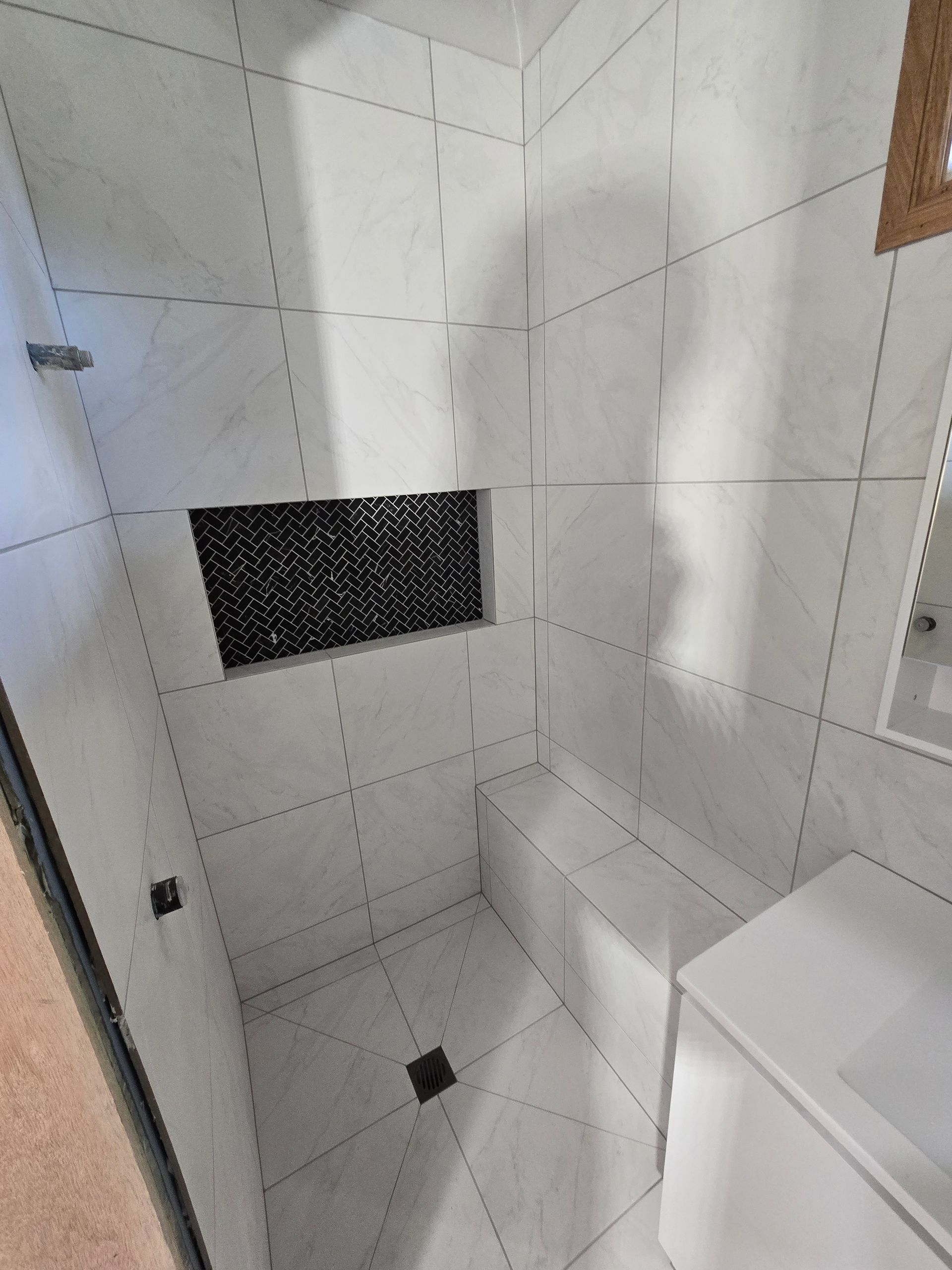 White-tiled Bathroom With A Sink, Mirror, And Cabinets — David Son Tiling in Springdale Heights, NSW