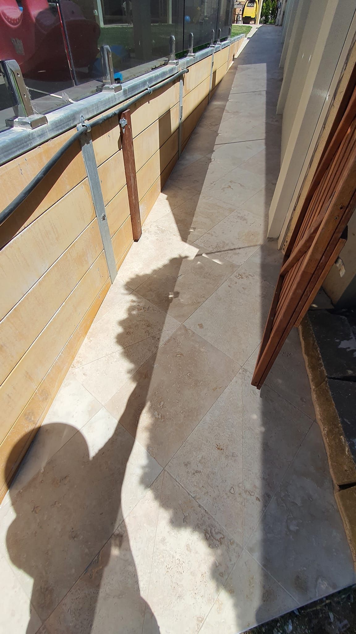 Front Porch With Patterned Tiles, Grey Siding, And White Columns — David Son Tiling in Springdale Heights, NSW