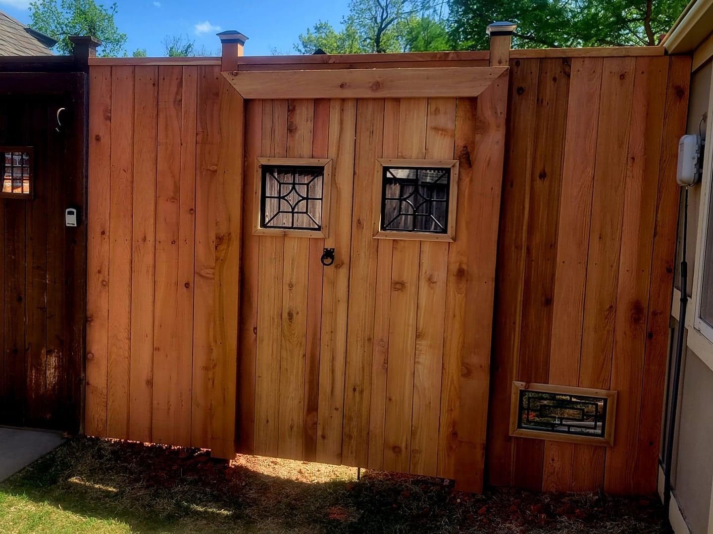 A wooden fence with a door in the middle of it.