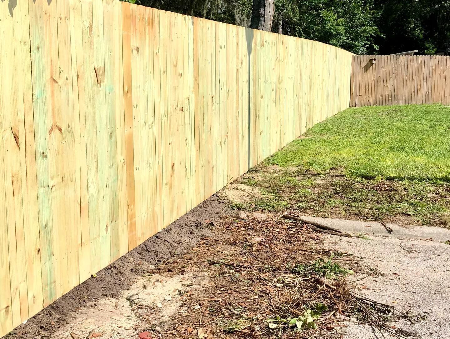 A wooden fence is sitting in the middle of a grassy field.