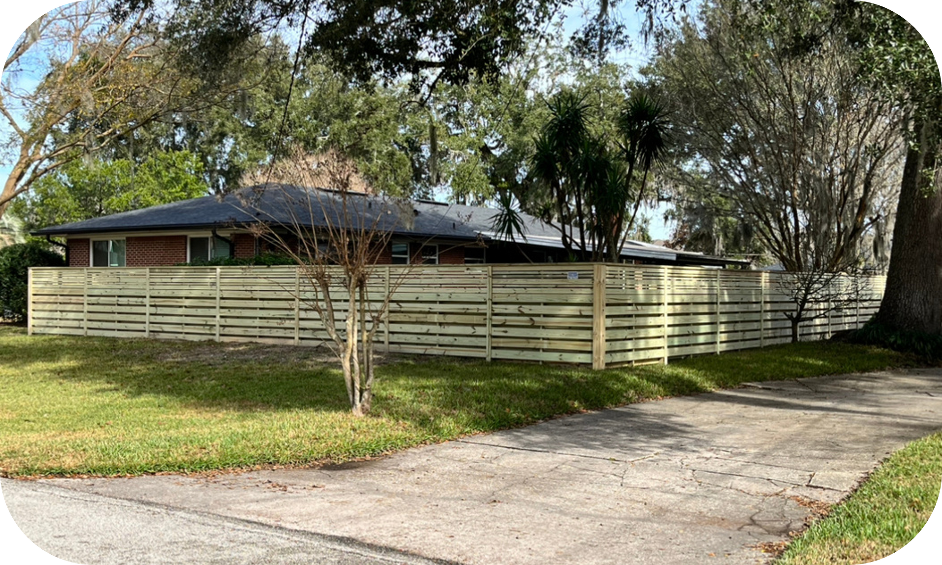 A house with a wooden fence in front of it.