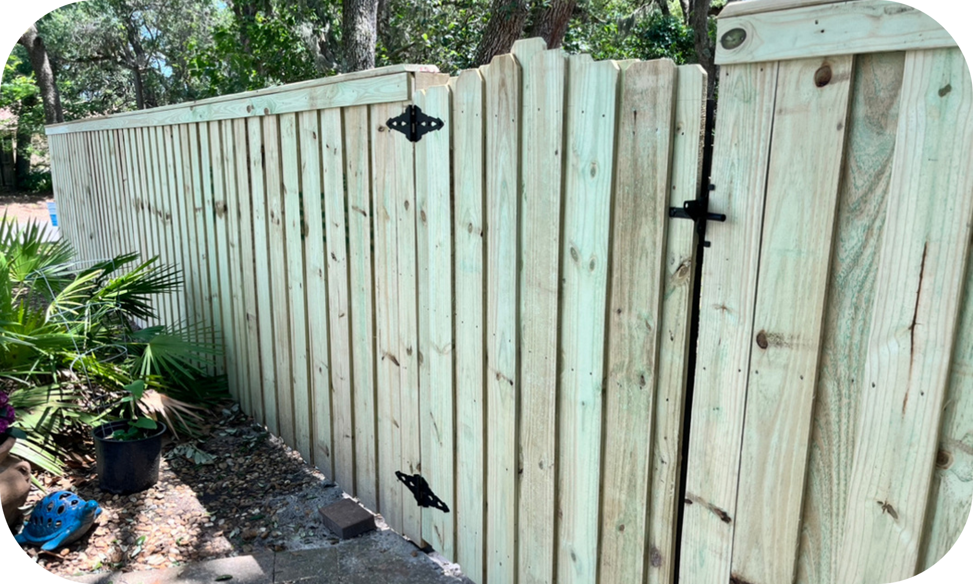A wooden fence with a gate in the middle of it.