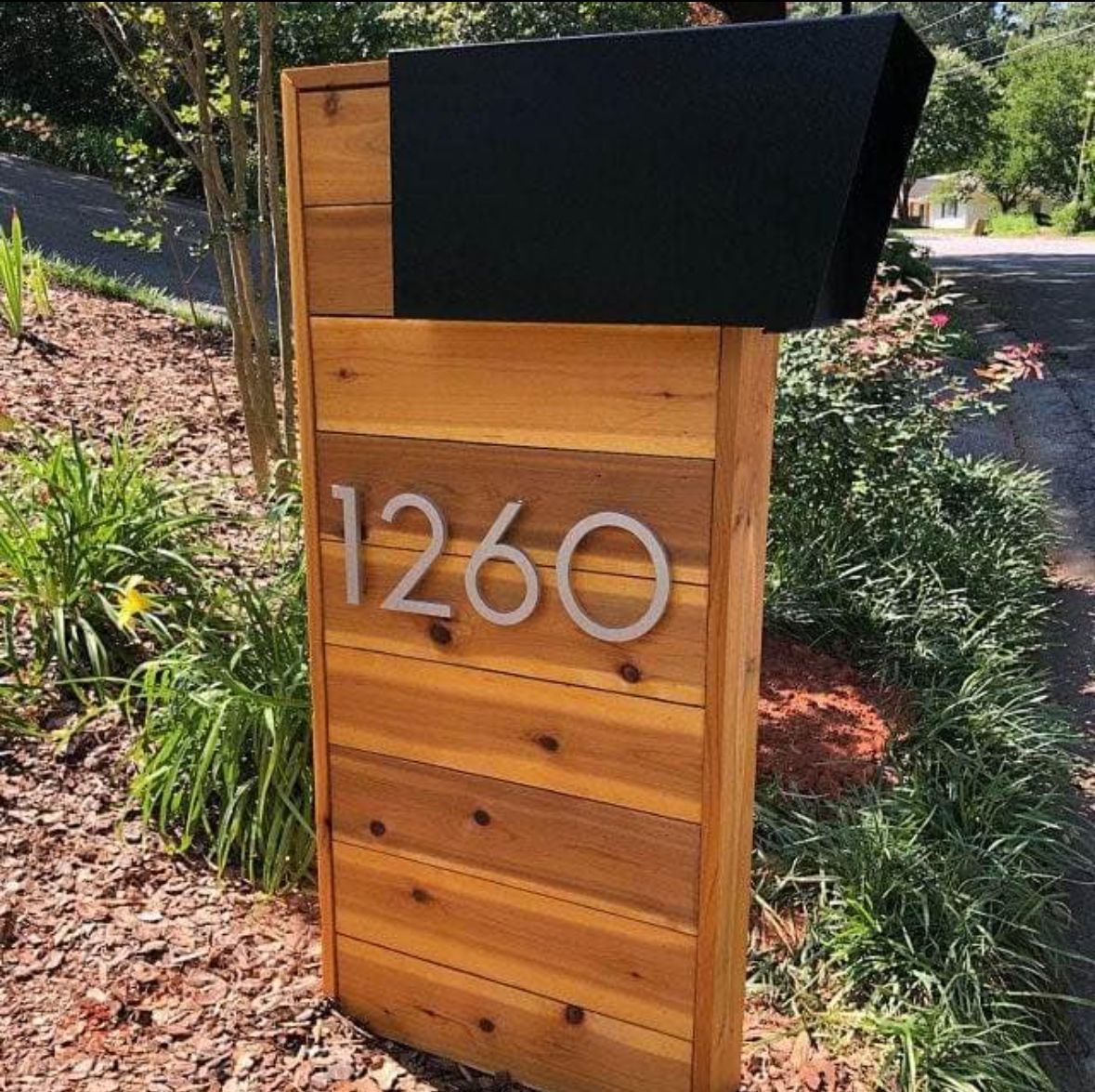 A wooden mailbox with the number 1260 on it