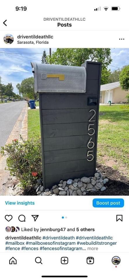 A picture of a mailbox on the side of a road.