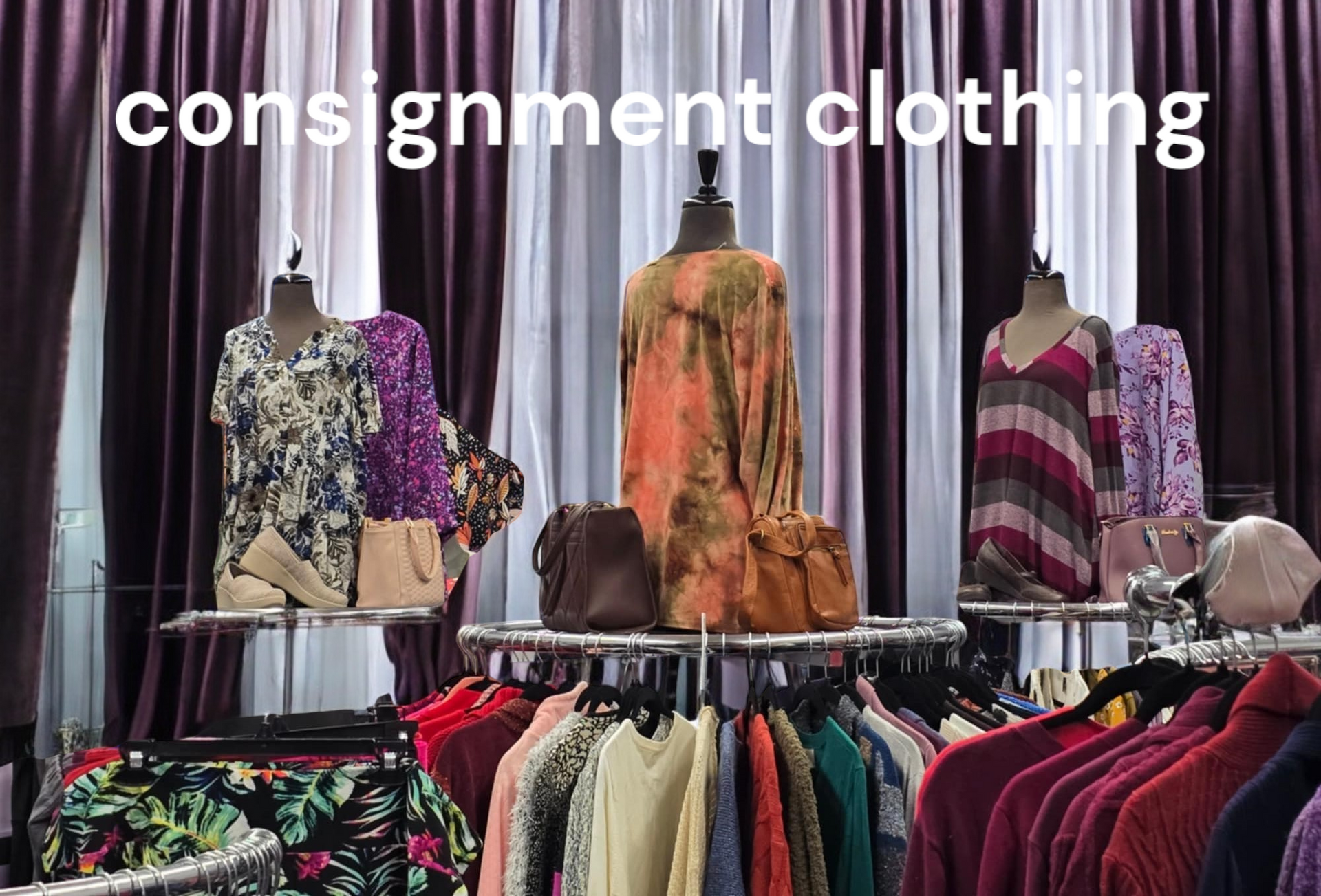 A bunch of clothes are hanging on racks in a store.