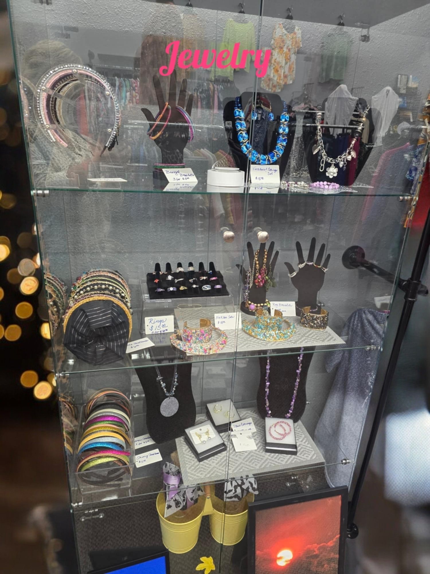 A display case filled with lots of jewelry including necklaces and bracelets.