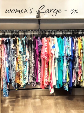 A closet filled with clothes and a sign that says `` women 's large - 3x ''.